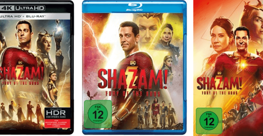 Der Superheld Shazam schaut in seinem roten Kostüm in die Kamera,. Vor seiner Brust der rote Schriftzug SHAZAM!. Im Hindergrund die Transparenten Gesichter von Nebendarsteler:innen